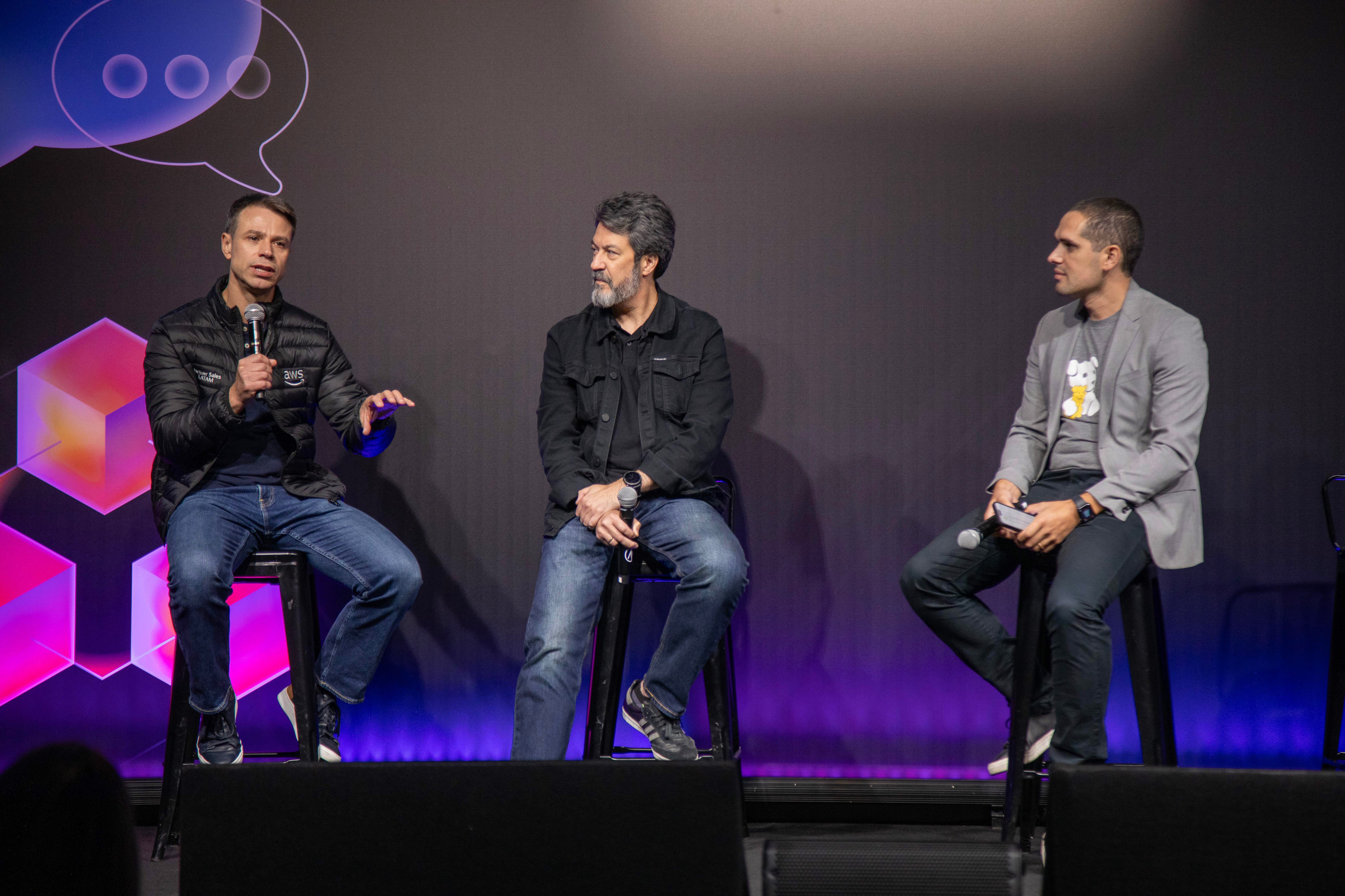 Three people address the audience during a Datadog Summit afternoon session.