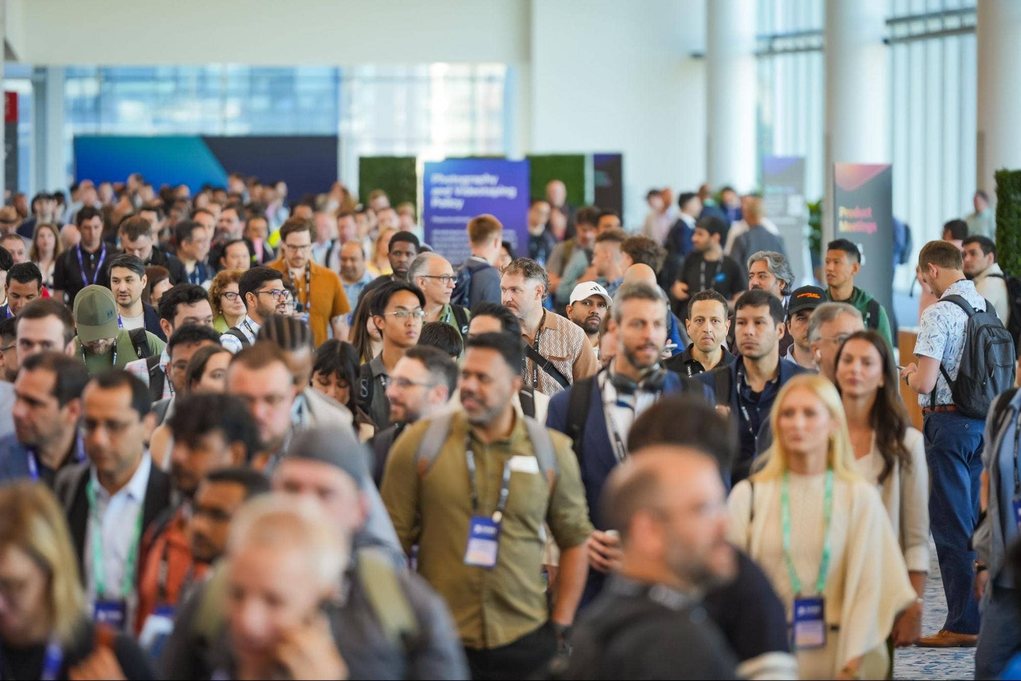Dozens of DASH attendees walking down a hallway at the Javits Center during a break between sessions.